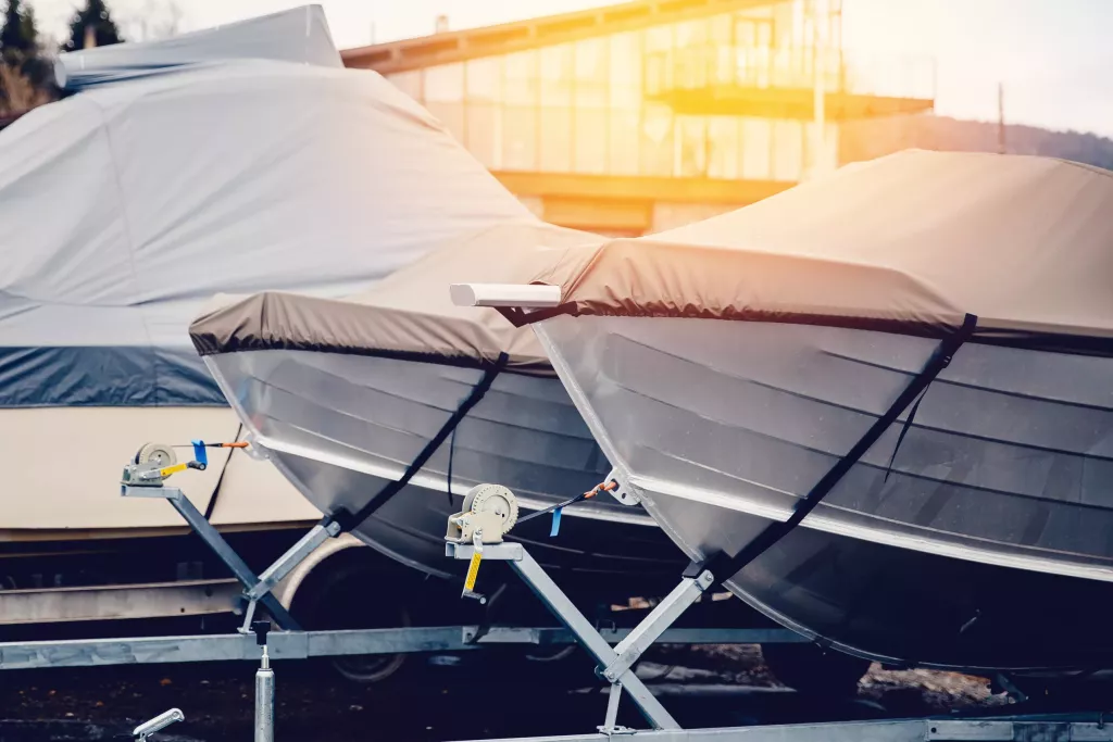 Row of boats in storage for the winter under the awning. Warehouse on the boat pier. Concept preparation for winter.