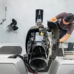 Repairing engines on aluminum boats , The technician is removing the boat parts to make the paint